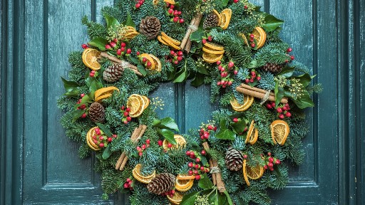 Christmas wreath hanging on house door