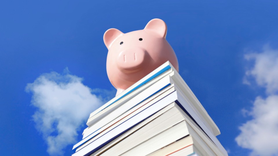 Piggy Bank sat on top of textbooks