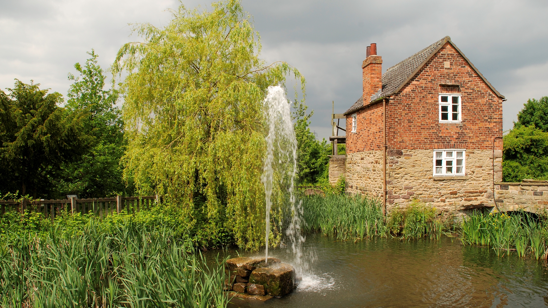 Rother Valley Mill with fountain and pond in foreground.