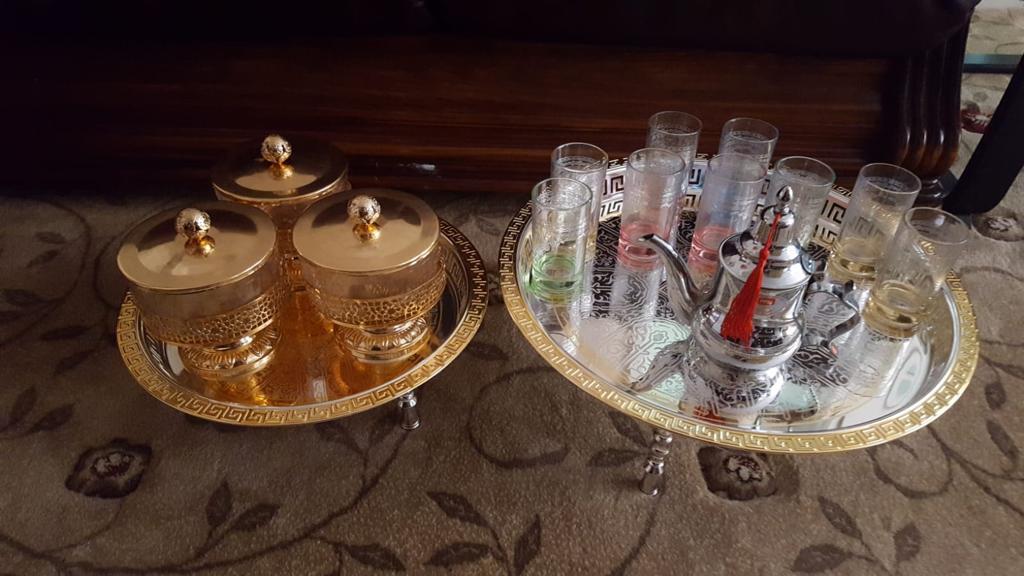 Two plates filled with glass canisters and objects.