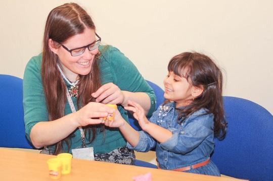 An adult and child talking