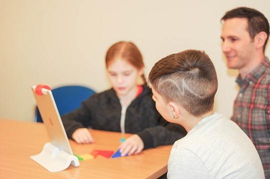 Two children talking with an adult