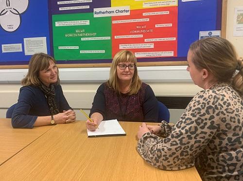 Three adults having a meeting