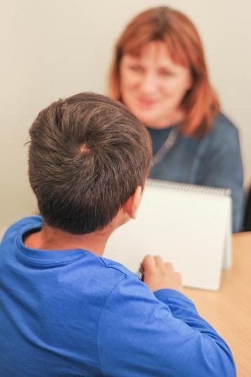 An adult and child talking