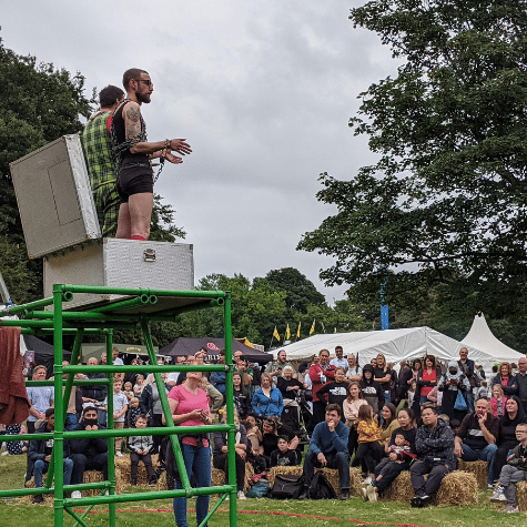 Two escape artists in a box on top of scaffolding