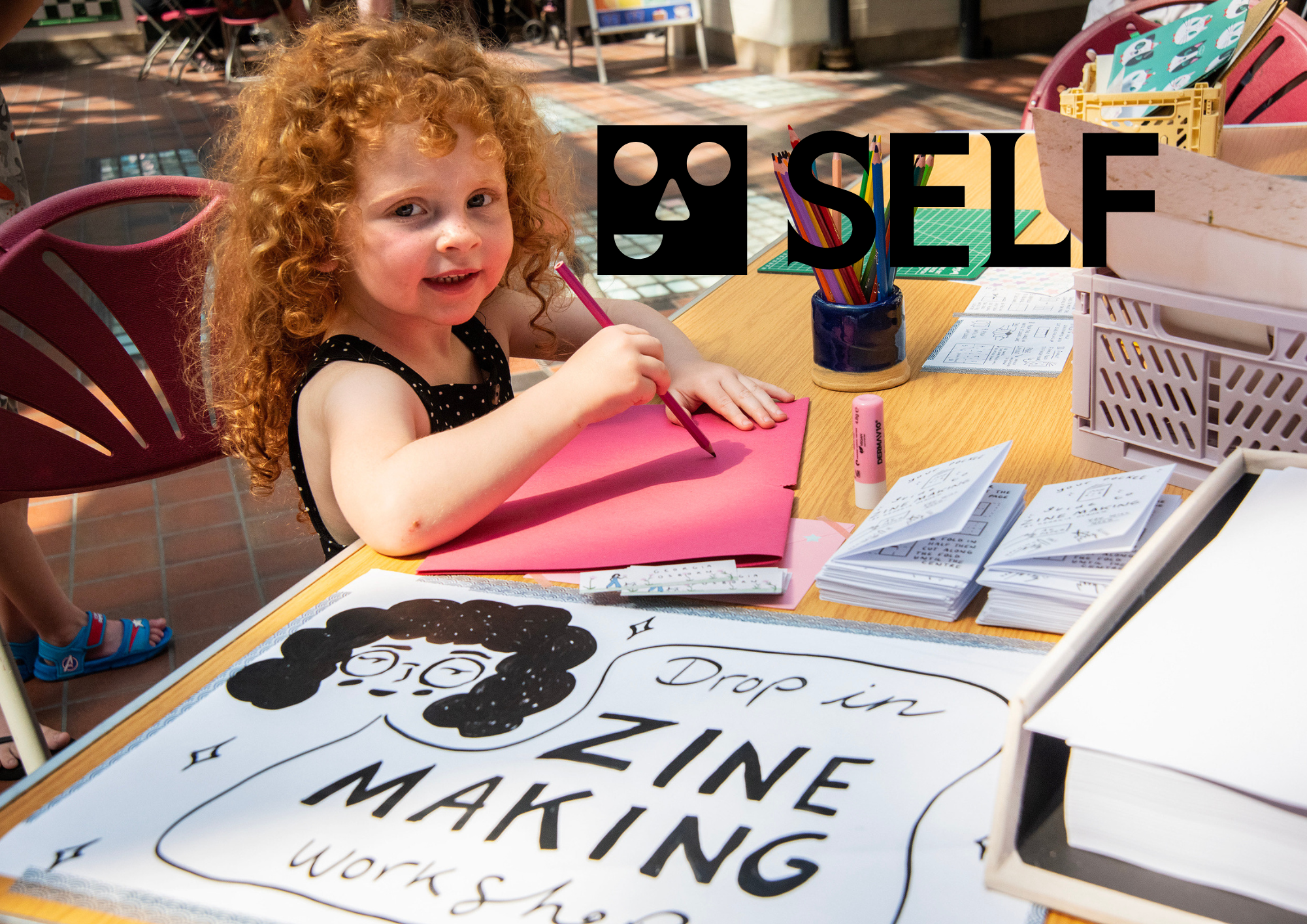 curly haired female child drawing