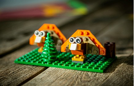 two brick figures and a tree
