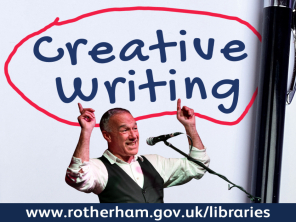 Ray Hearne with a microphone and pointing to the words 'creative writing'