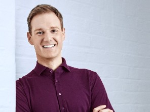 Dan Walker smiling with arms folded