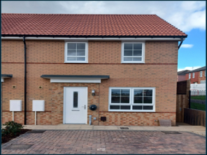 A semi-detached house with a driveway in front of the property.