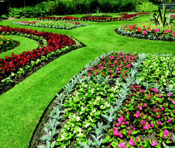 A grass section with an assortment of colourful flower beds.
