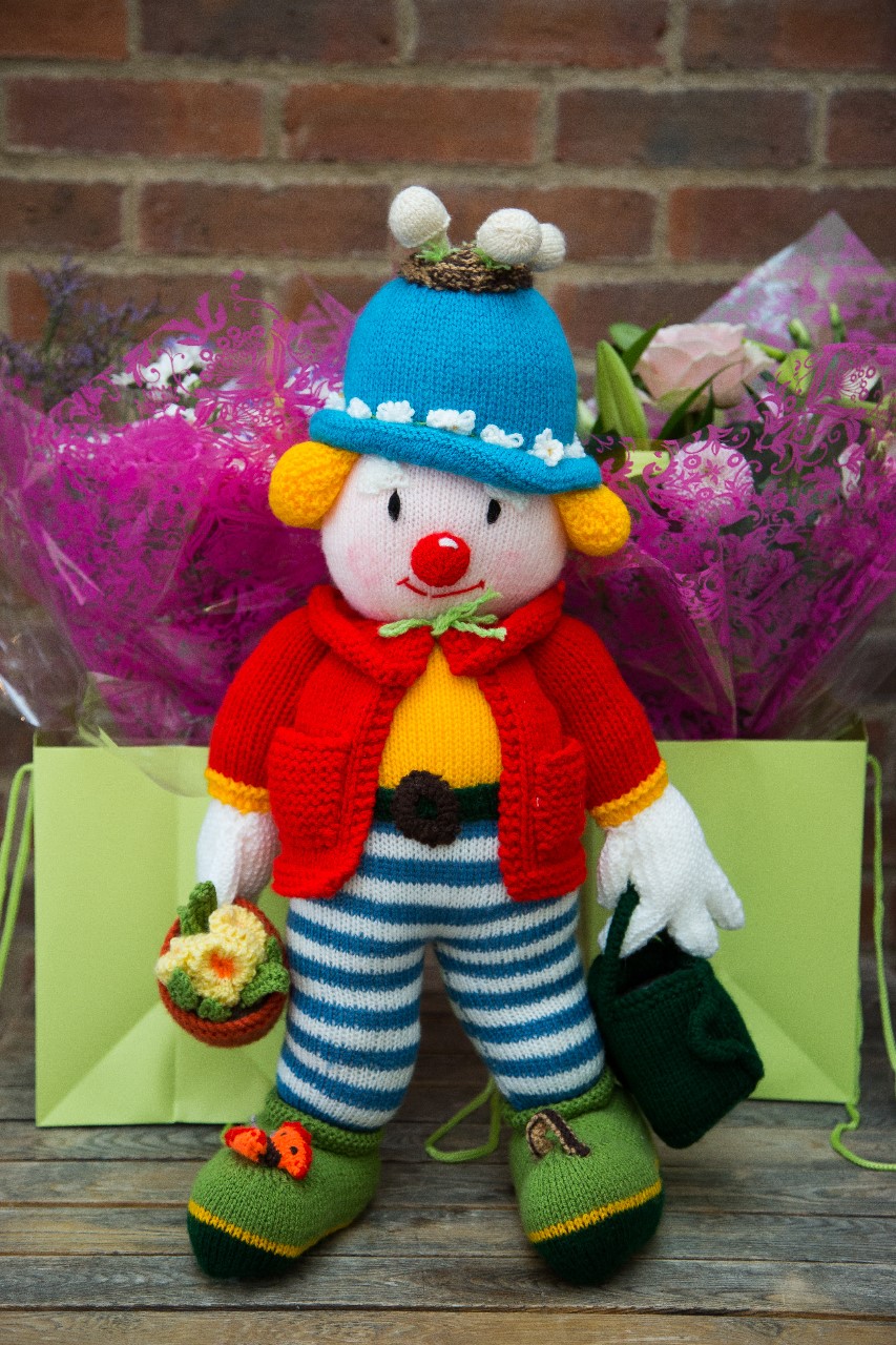 photo of of a knitted garden clown figure
