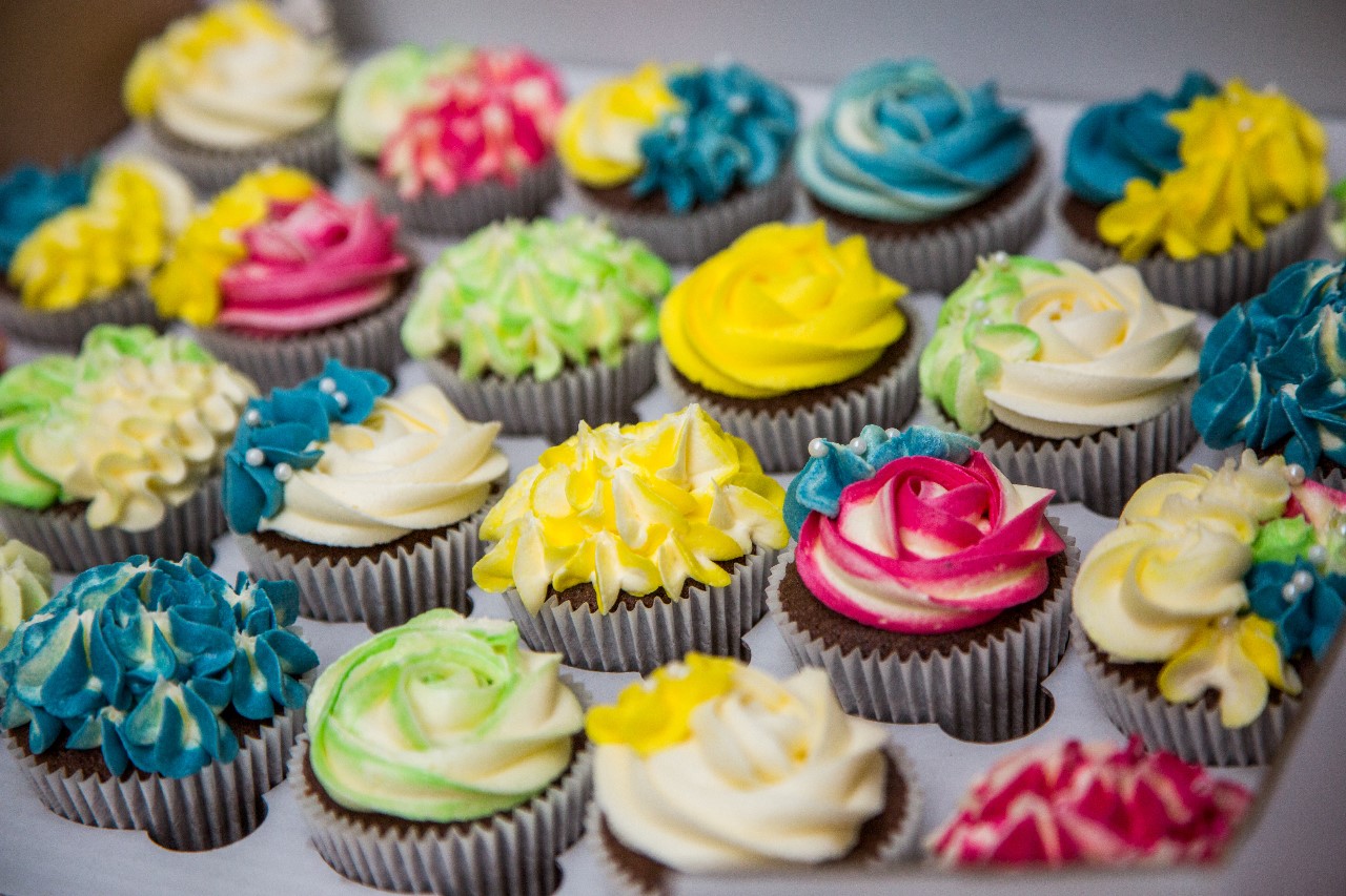 photo of a selection of vibrant coloured cupcakes