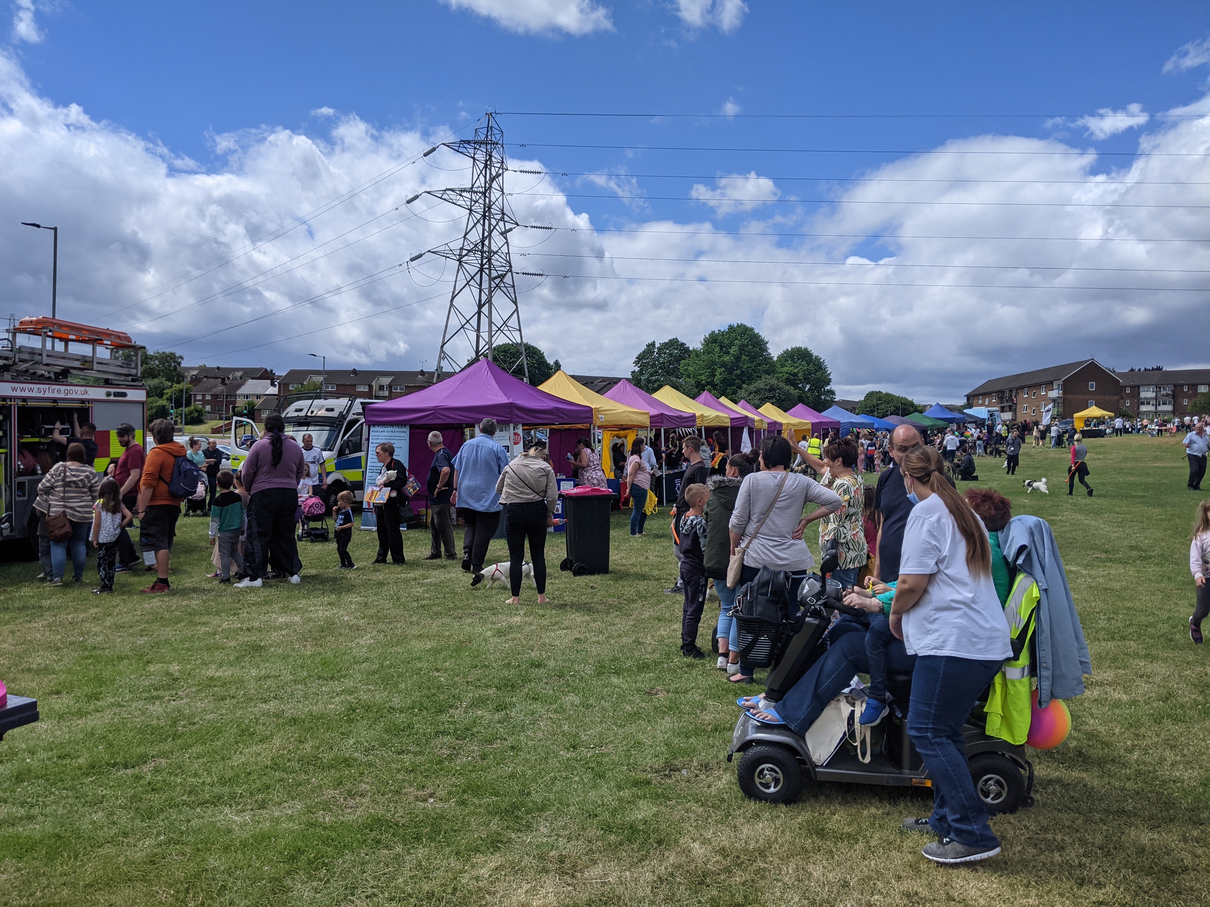 The image shows attendees and stalls at the Greasbrough fete