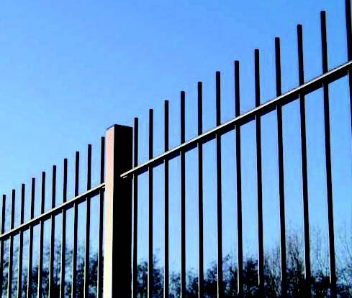 A new black fence with a blue sky background.