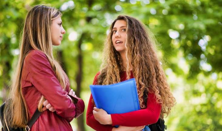 Two women having a conversation outdoors.