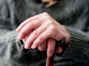 Older person with walking stick