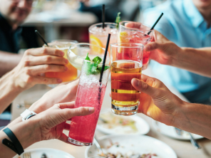 A group of friends doing cheers with their drinks