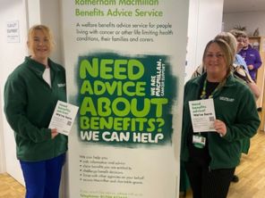 Two people stood either side of a portrait Macmillan banner