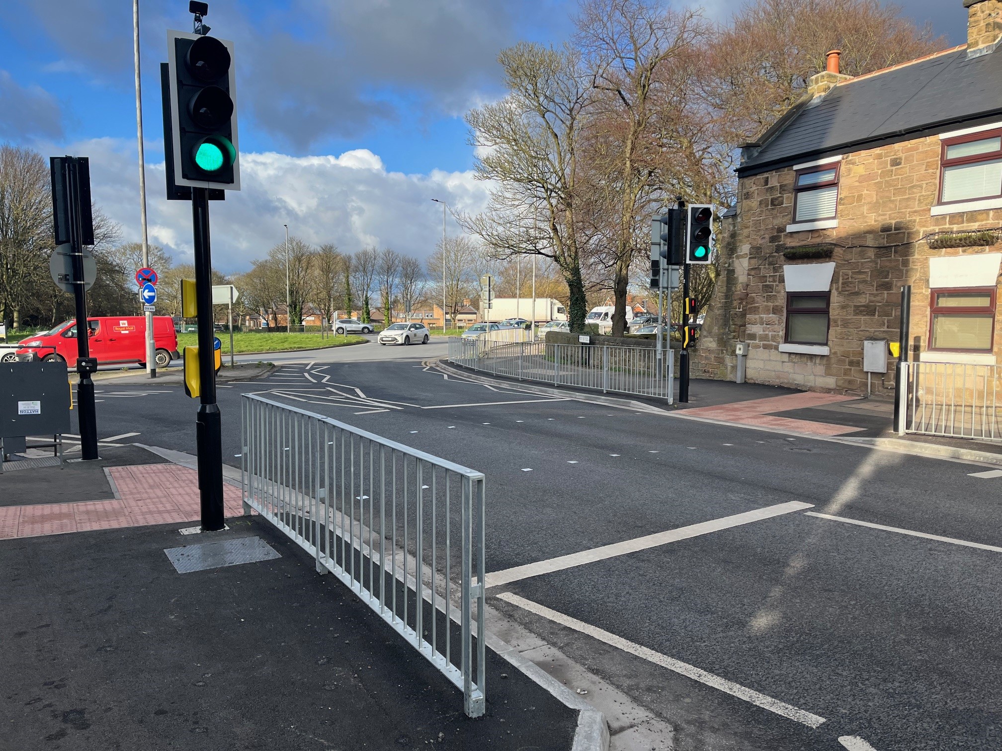 A photo of Morthen Road in Wickersley picturing a traffic light before a roundabout.
