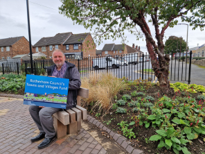 Cllr Sheppard sitting a bench where the project has taken place.