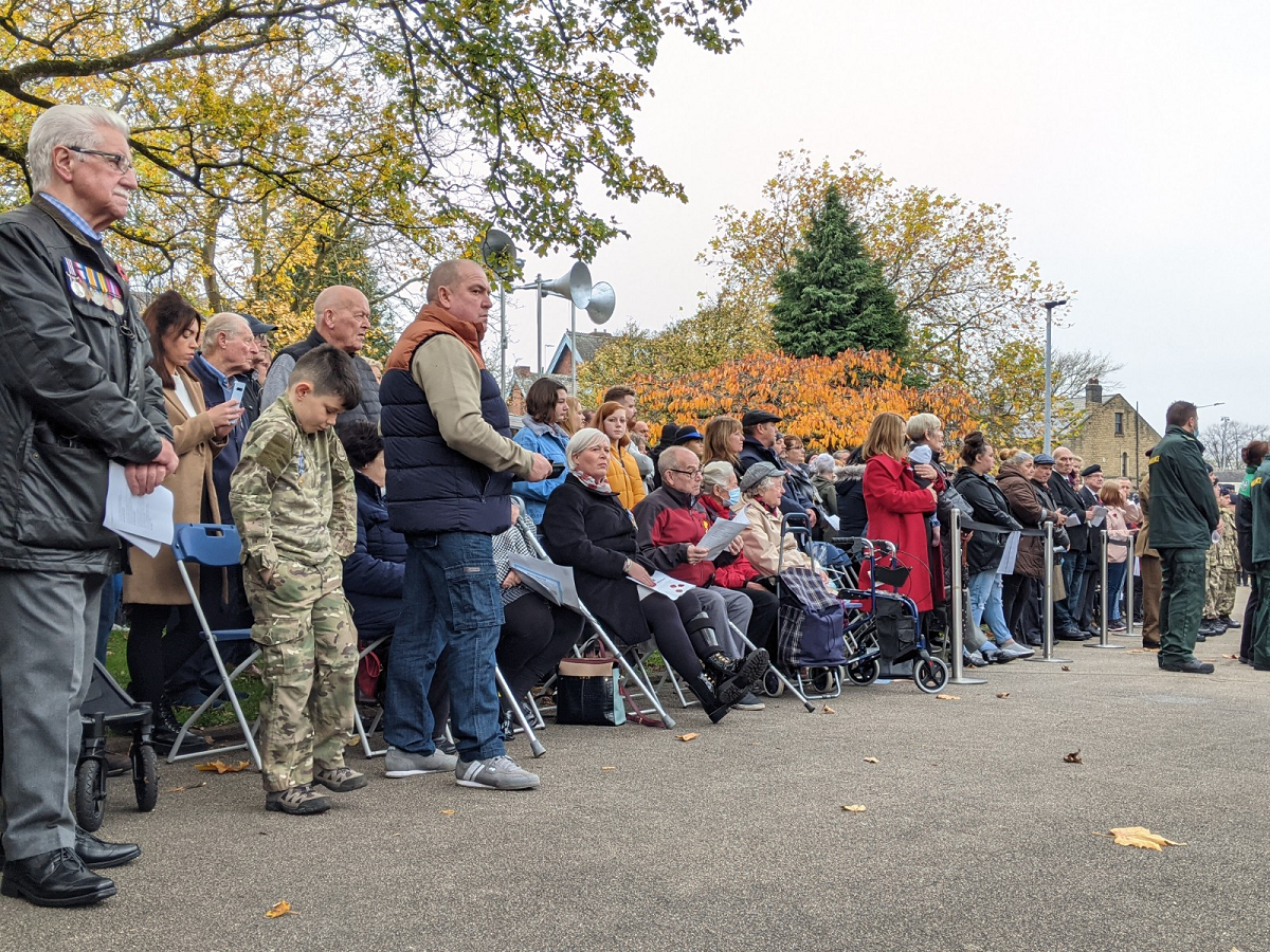 Crowd of local people, including retired military personnel wearing medals, at 2021 Rotherham Remembers event in Clifton Park