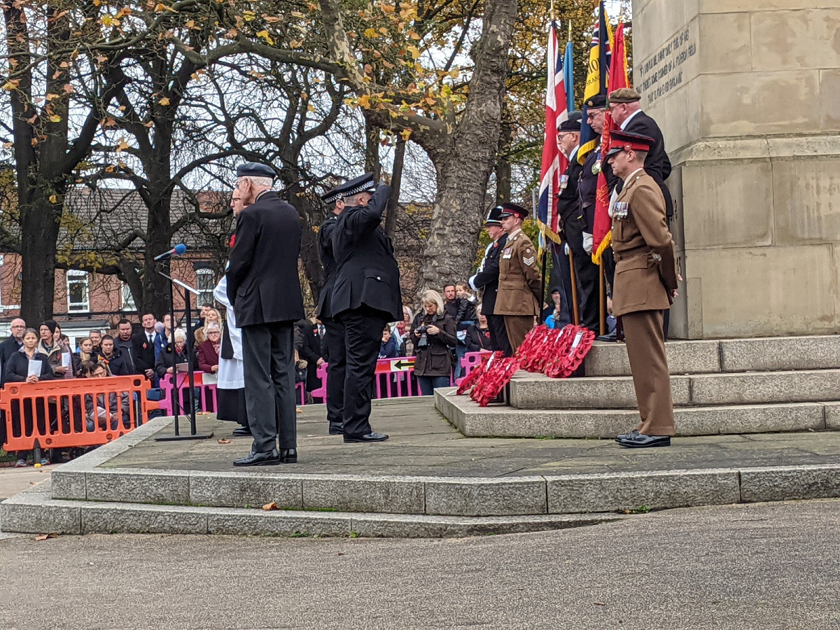 South Yorkshire Police representatives in uniform salute the Clifton Park cenotaph at 2021 Rotherham Remembers event