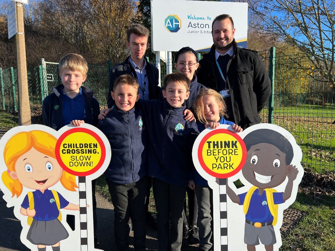 Councillor Bacon with the Head Teacher and pupils from Aston Hall Junior and Infants School, stood next to the Parking Buddies outside the school