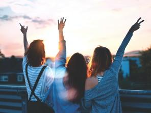 Three teenagers cheering