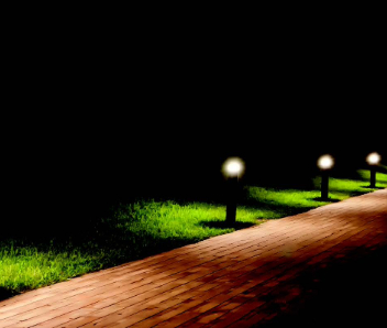 A night time photo of black lighting pillars lining a path