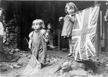 Two young girls holding British flags celebrating VE Day