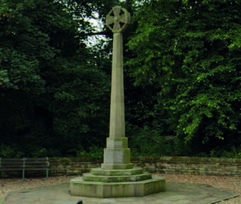 A Cenotaph with a black railing around it.
