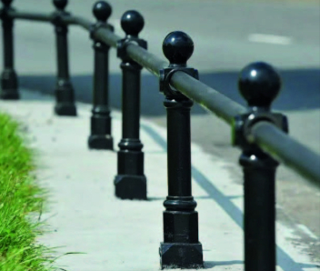 Black railings are shown on a grey stone path.