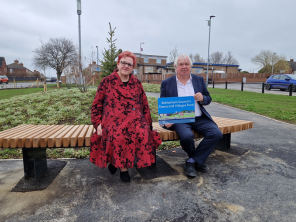An image of councillor Sarah Allen with Councillor David Roche who are sat on the newly installed benches