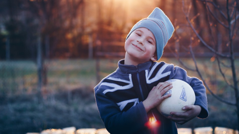 Boy holding football in his hands