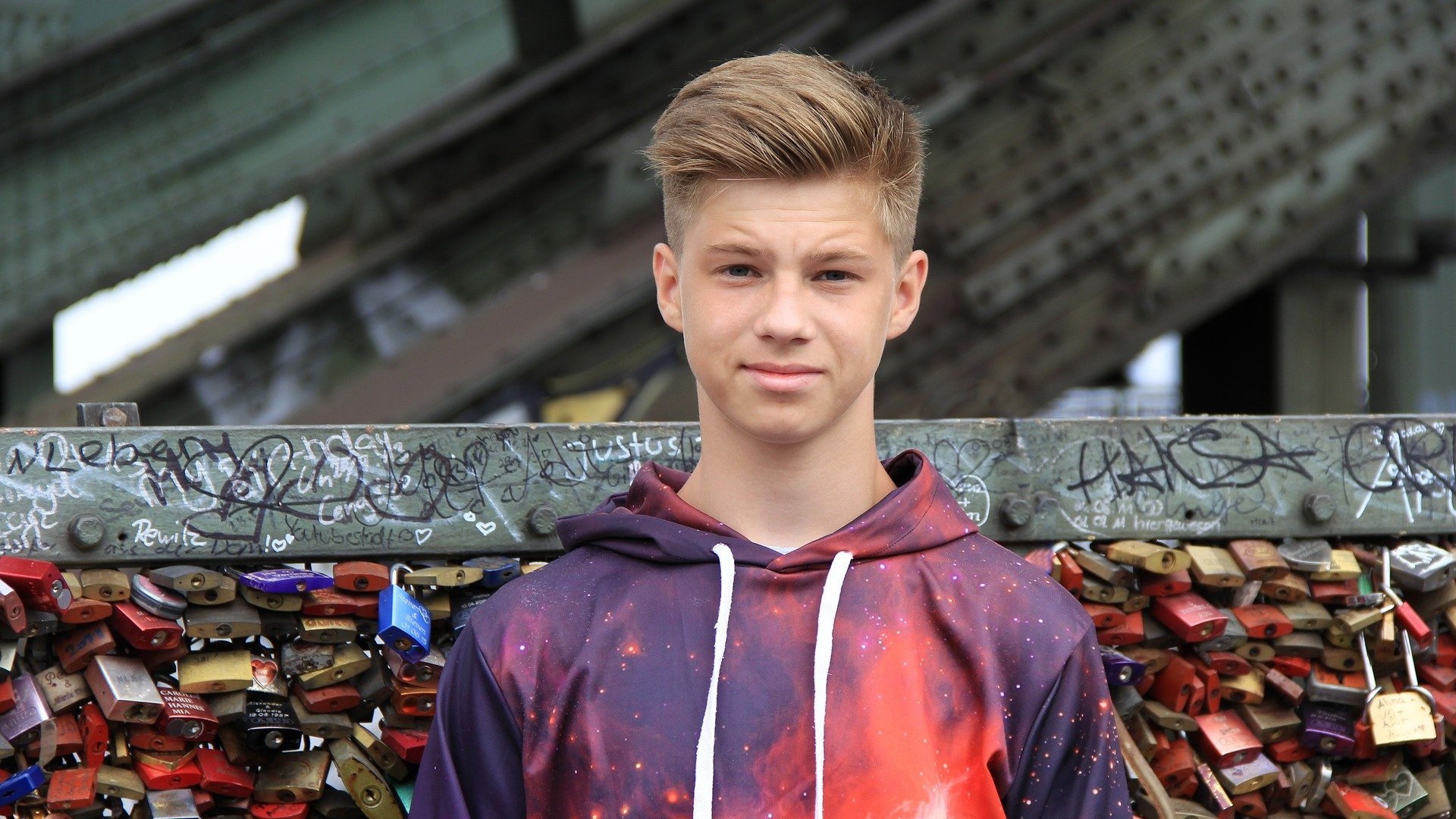 Boy with locks on bridge