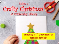 Hand with craft materials crafting a christmas tree design on a card