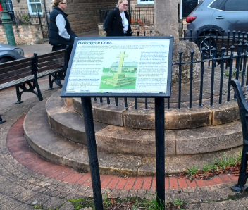 A notice board in front of the cenotaph.
