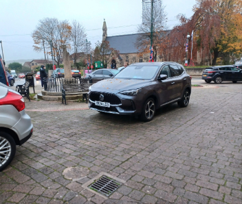 Cars parked on the path next to the cenotaph.