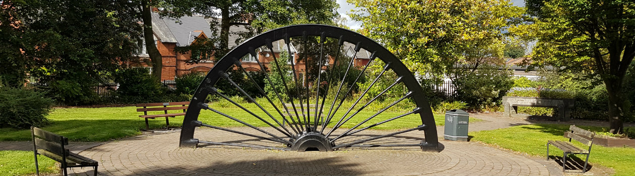 Photo of a half mill wheel located within a public green space