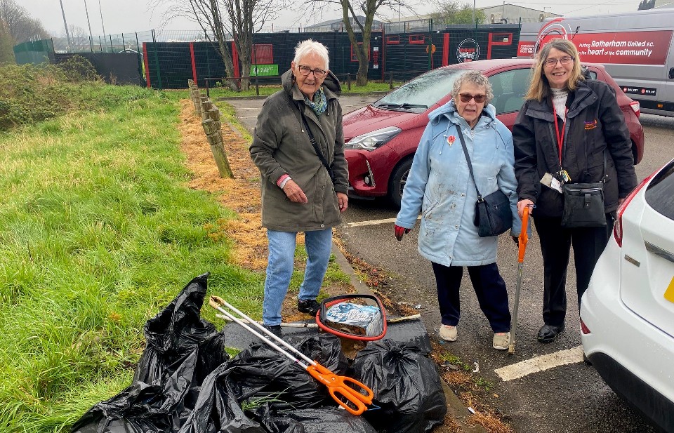 Local people on a community litter pick with bags of collected rubbish