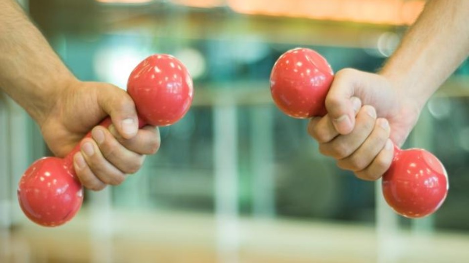 Hands holding exercise weights