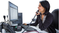 A women at a desk on the telephone