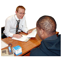 Two men talking at a desk