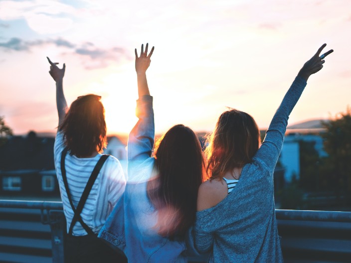 Group of young people watching the sunset