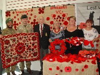 Group of people holding poppy displays