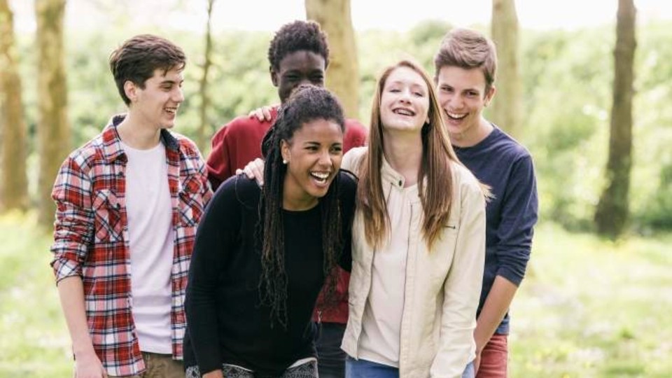 Group of young people walking and laughing