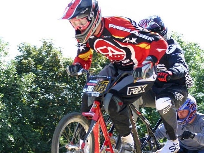 BMX racing with rider going over a jump