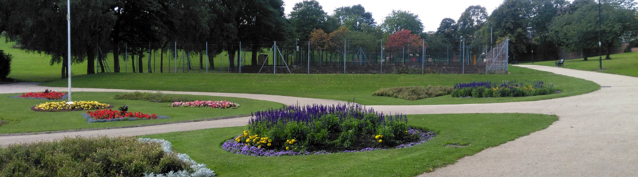 photo of a greenspace with multiple flower beds