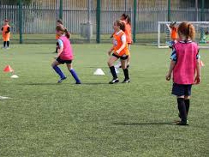 RUCST girls learning football skills